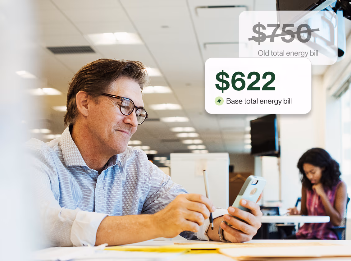 A business owner reviewing a lower energy bill with Base