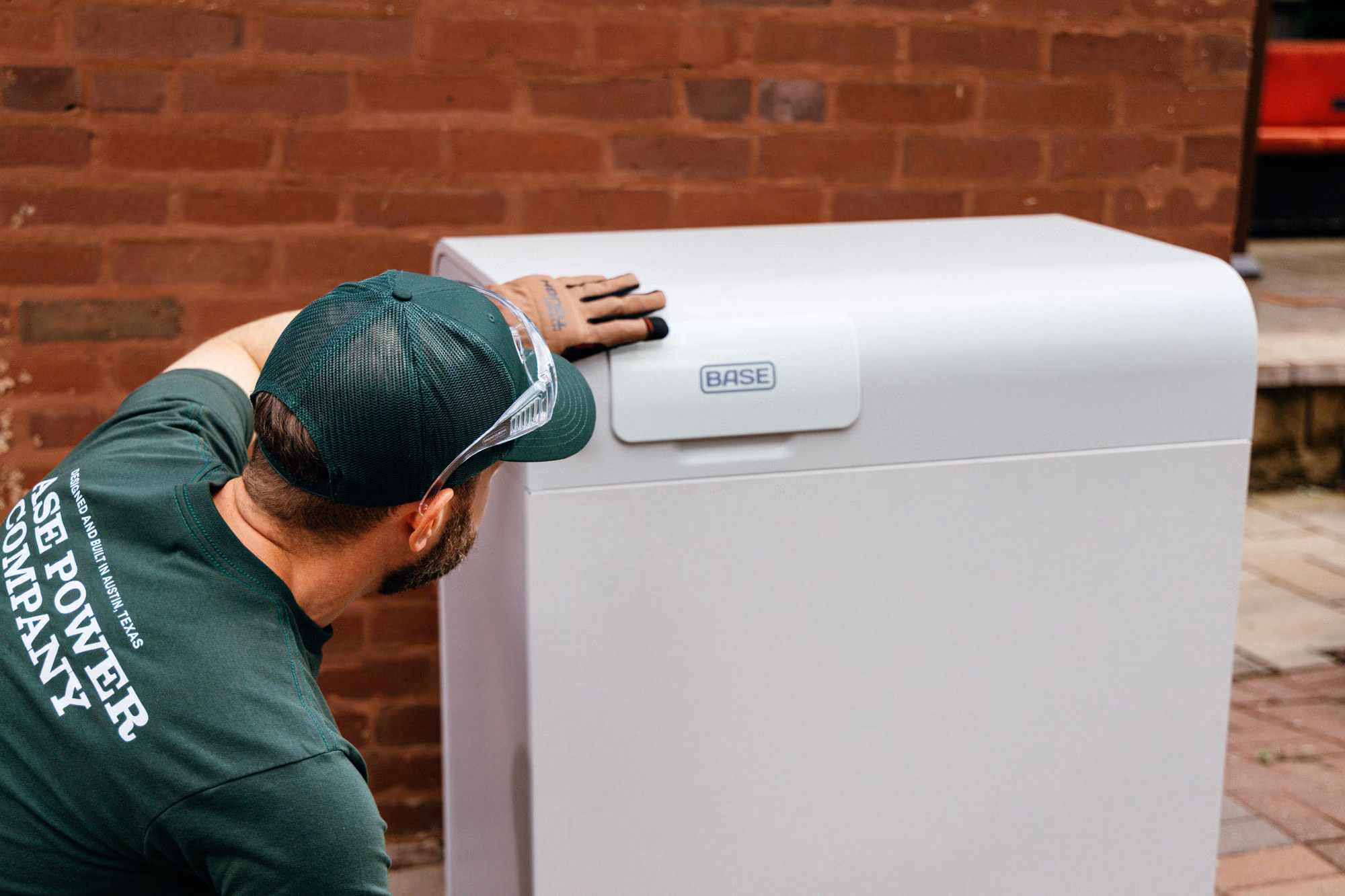 A Base technician installing a home battery