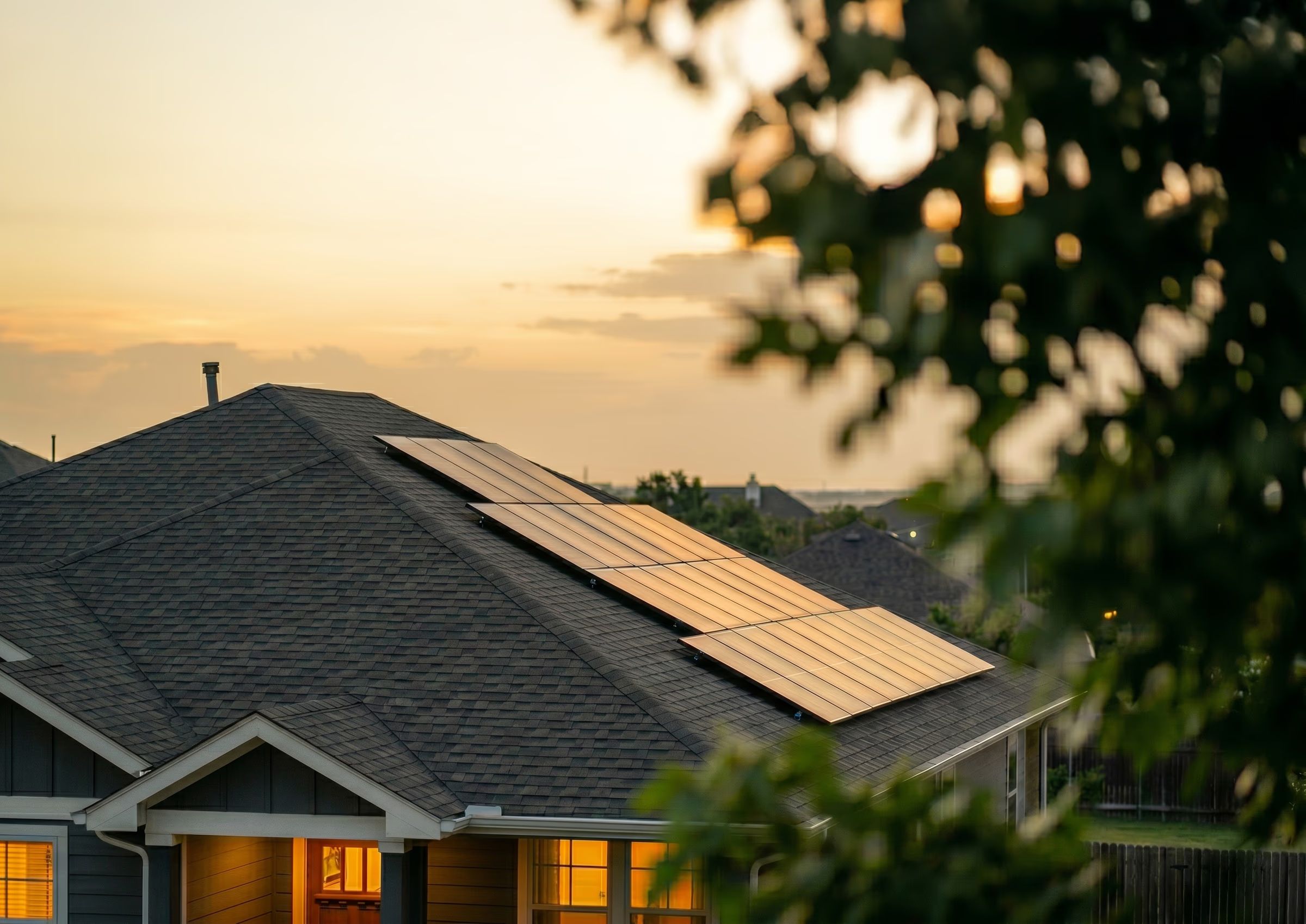A modern Texas home with rooftop solar panels at sunset