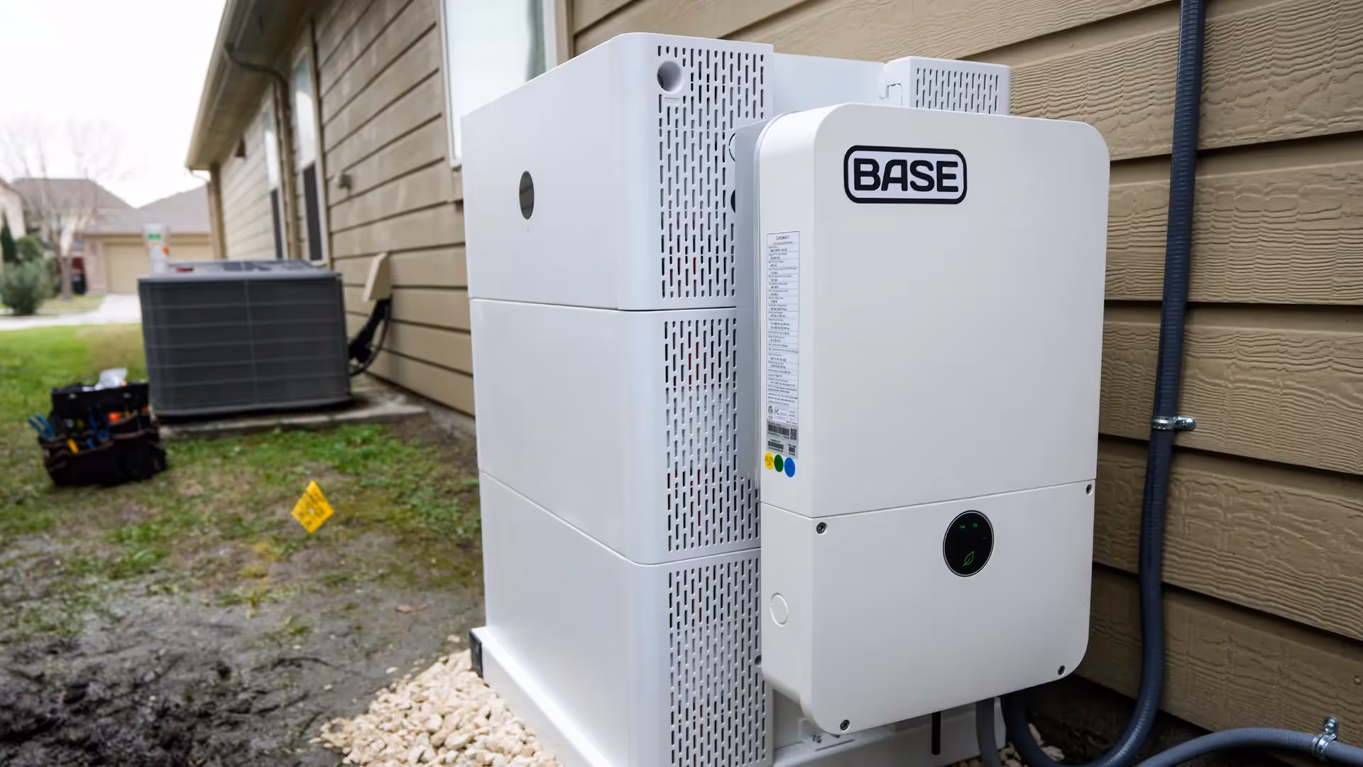 Base Power home batteries beside a house